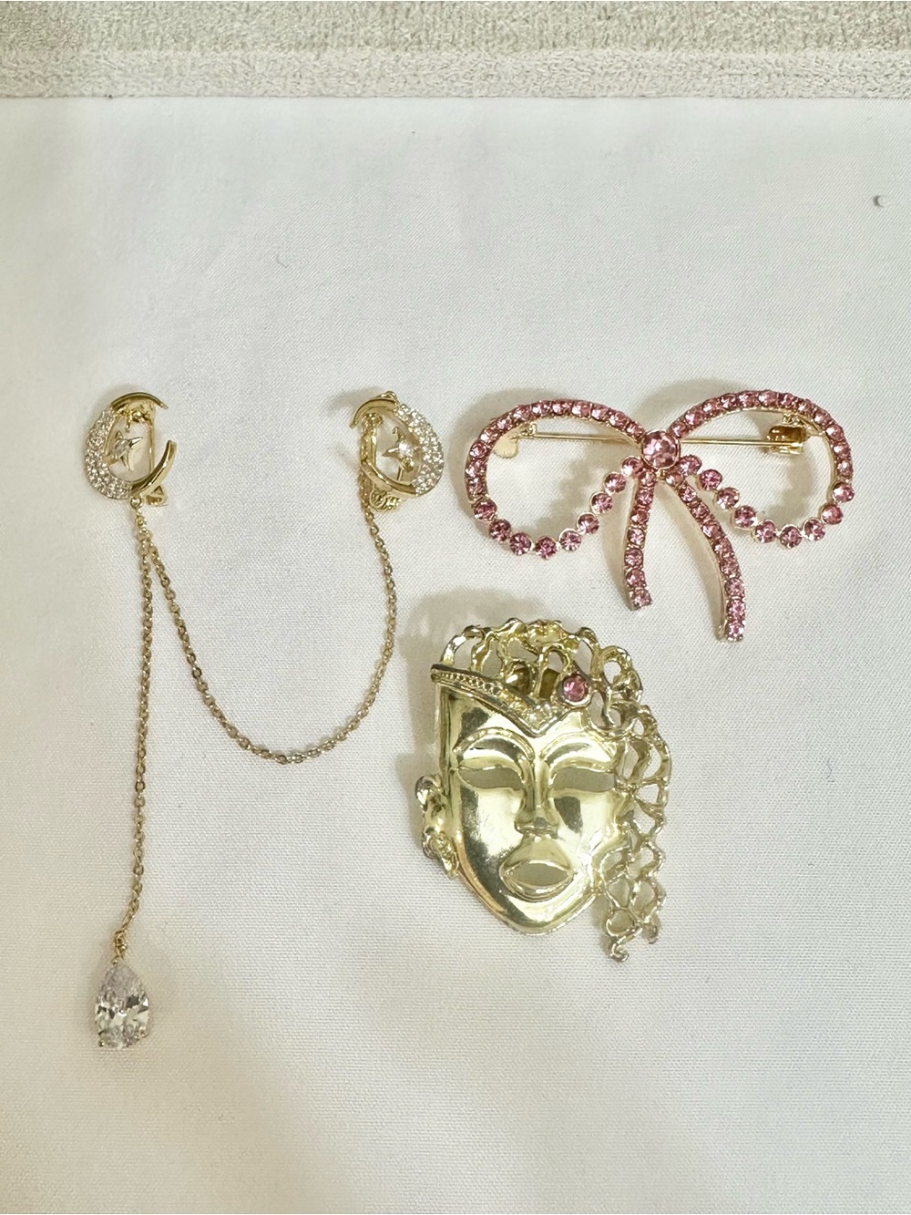 Gold Tone Sculptural Face Brooch with Pink Crystal Bow Accent